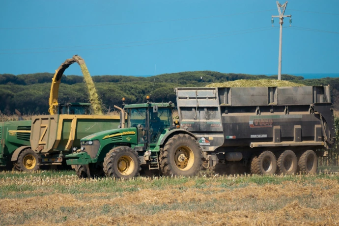 A tractor and a tractor trailer in a field